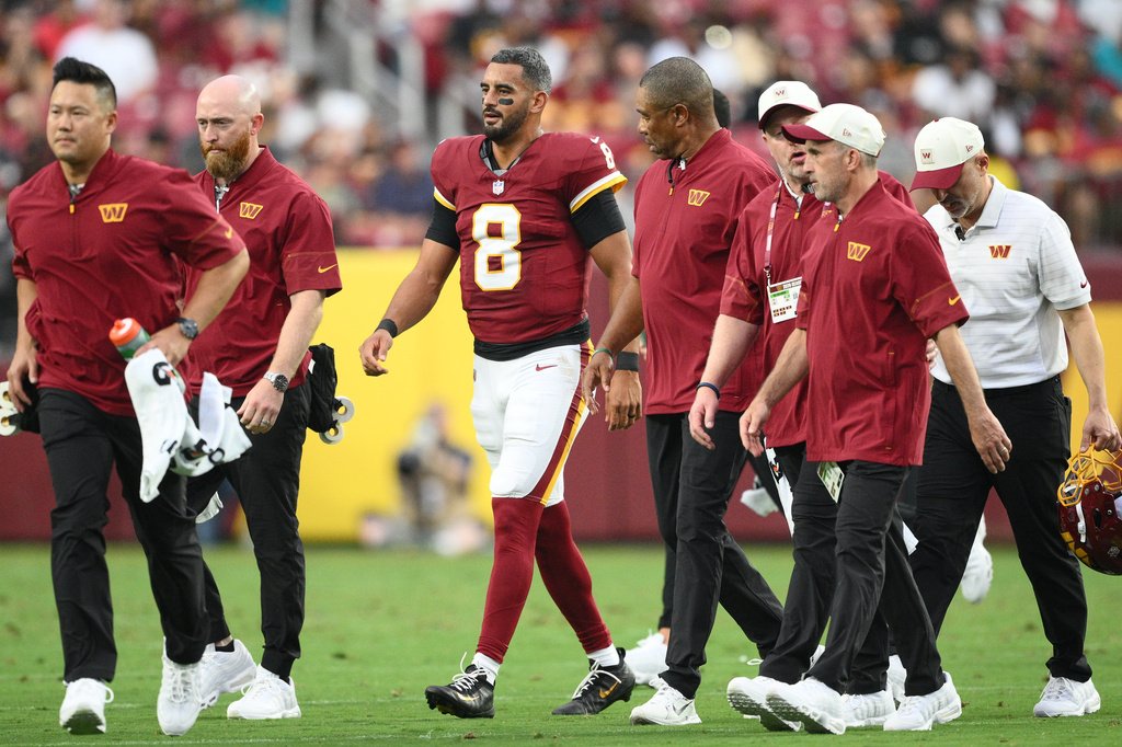 Washington Commanders quarterback Marcus Mariota (8) walks off the field during the first half of an NFL preseason football game against the Miami Dolphins, Friday, Aug. 14, 2026, in Landover, MD. (AP Photo/Nick Wass)
