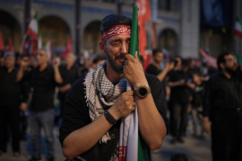 A man weeps during funeral ceremonies for slain Iranian Supreme Leader Ayatollah Ali Khamenei and members of his family at the Imam Khomeini Mosalla Grand Mosque in Tehran, Iran, Sunday, July 5, 2026. (AP Photo/Altaf Qadri)