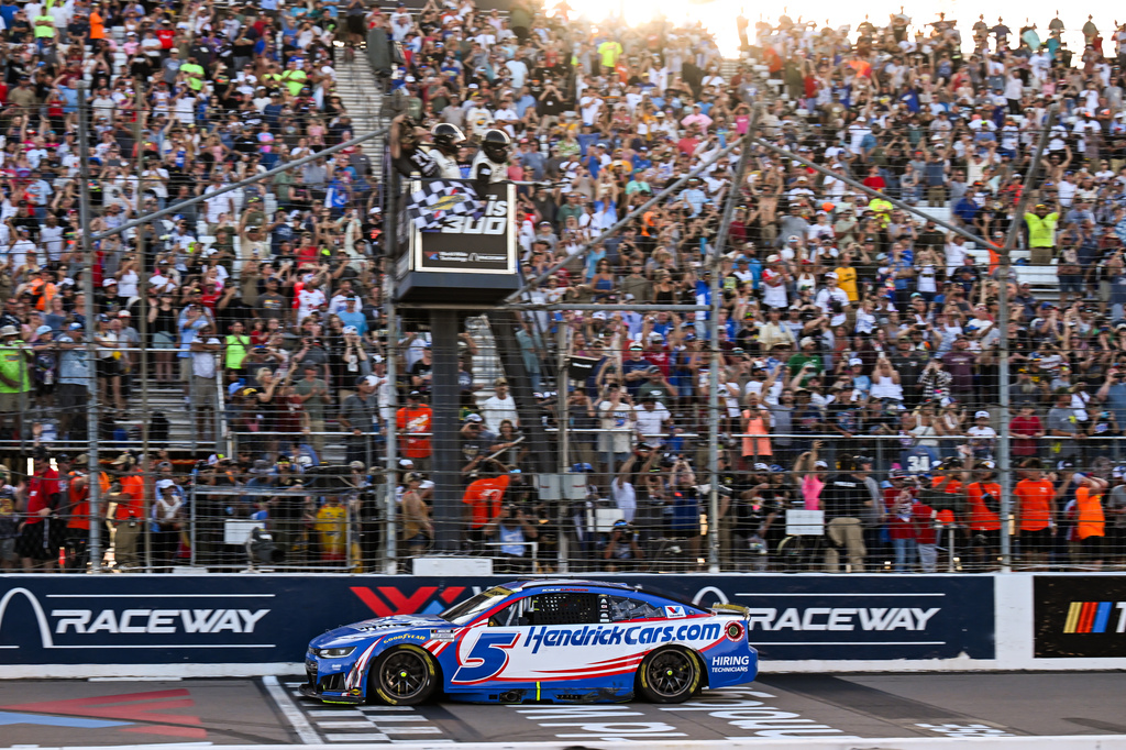 Kyle Larson takes the checkered flag during a NASCAR Cup Series auto race Sunday, Sept. 13, 2026, in Madison, Ill. (AP Photo/Connor Hamilton)