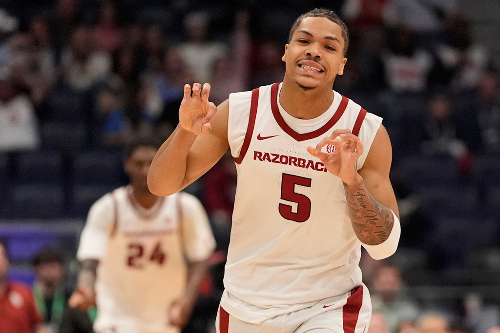Arkansas guard Darius Acuff Jr. (5) celebrates a three-point basket against Oklahoma during the first half of an NCAA college basketball game in the quarterfinal round of the Southeastern Conference tournament, Friday, March 13, 2026, in Nashville, Tenn. (AP Photo/George Walker IV)