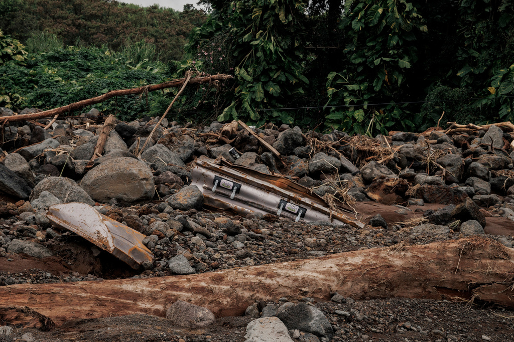 A casket washed away from Naalehu Cemetery is seen in a debris field after Hurricane Lala in Naalehu, Hawaii, Monday, Aug. 17, 2026. (Stephen Lam/San Francisco Chronicle via AP)