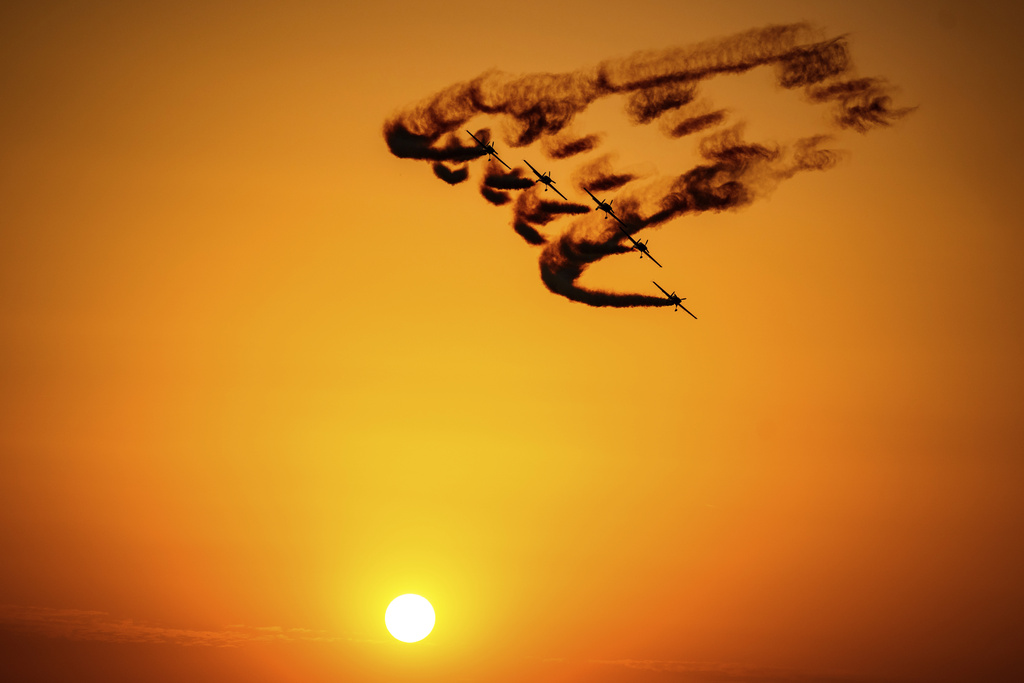 Pilots of the Hawks of Romania aerobatic team perform above the runway of the Aurel Vlaicu airport, on the first day of the Bucharest International Air Show, BIAS 2025 in Bucharest, Romania, Saturday, Aug. 30, 2025. (AP Photo/Andreea Alexandru)