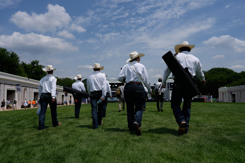 Texas high school students walk up the National Mall to the stage to present their mobile cattle dipping vat they built to protect cattle during the Great American State Fair on Friday, June 26, 2026, in Washington. (AP Photo/Carolyn Kaster)