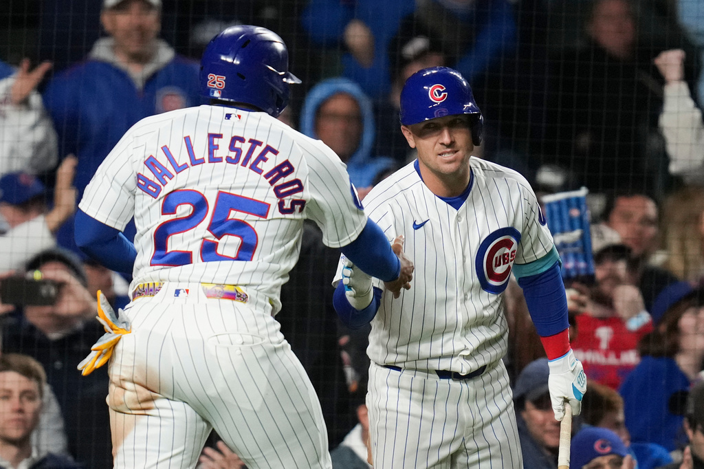 Chicago Cubs designated hitter Moisés Ballesteros (25) celebrates with Alex Bregman (3) after scoring on a single from Pete Crow-Armstrong (4) during the eighth inning of a baseball game against the Philadelphia Phillies, Wednesday, April 22, 2026, in Chicago. (AP Photo/Erin Hooley)