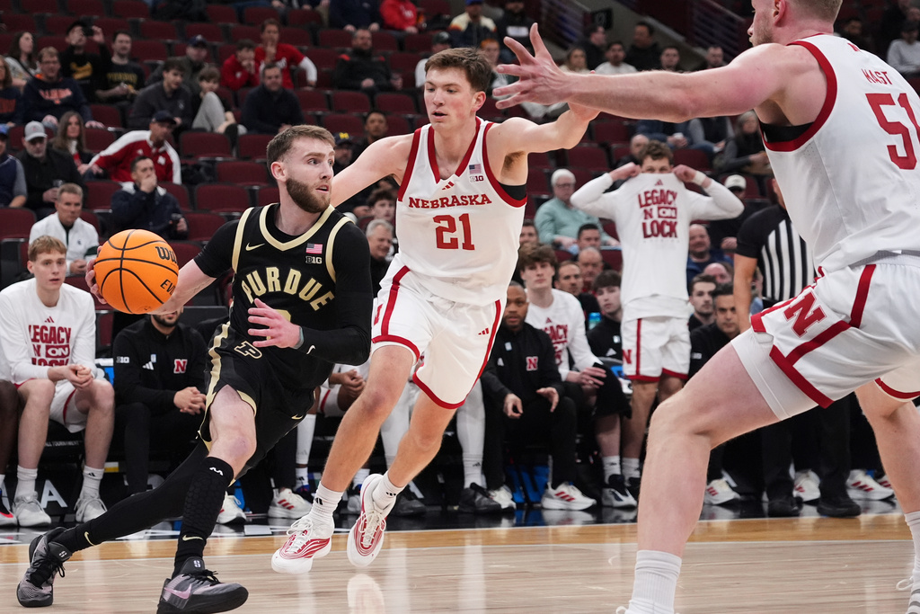 Purdue guard Braden Smith, left, drives as Nebraska forward Pryce Sandfort (21) and Nebraska forward Rienk Mast guard during the first half of an NCAA college basketball game in the quarterfinals of the Big 10 Conference tournament, Friday, March 13, 2026, in Chicago. (AP Photo/Nam Y. Huh)