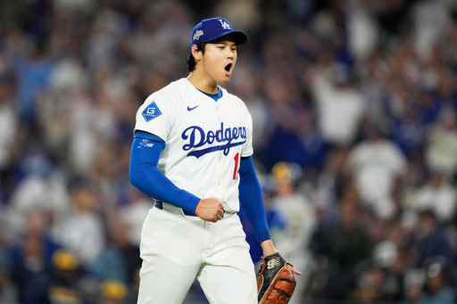 Los Angeles Dodgers pitcher Shohei Ohtani celebrates the end of the top of the third inning against the Milwaukee Brewers in Game 4 of baseball's National League Championship Series, Friday, Oct. 17, 2025, in Los Angeles. (AP Photo/Ashley Landis) Los Angeles Dodgers pitcher Shohei Ohtani celebrates the end of the top of the third inning against the Milwaukee Brewers in Game 4 of baseball's National League Championship Series, Friday, Oct. 17, 2025, in Los Angeles. (AP Photo/Ashley Landis)