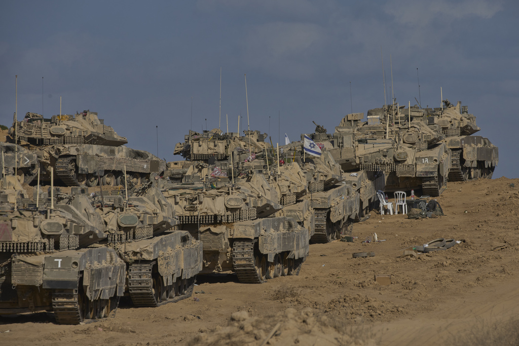 Israeli tanks at a staging area near the border with the Gaza Strip, in southern Israel, Sunday, Sept. 21, 2025. (AP Photo/Ohad Zwigenberg)