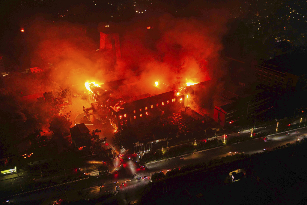 Flames come out from the residence of Nepal President Ram Chandra Poudel after it was set on fire by protesters during a protest against social media ban and corruption in Kathmandu, Nepal, Tuesday, Sept. 9, 2025. (AP Photo/Prabin Ranabhat)