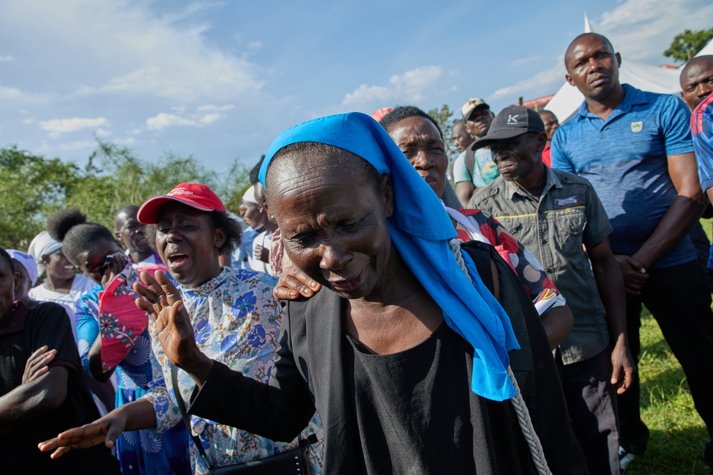 Professional mourners grieve alongside family members and friends of the deceased during a funeral on the outskirts of Kisumu, Kenya, Friday, March 13, 2026. (AP Photo/Asa Wallin)