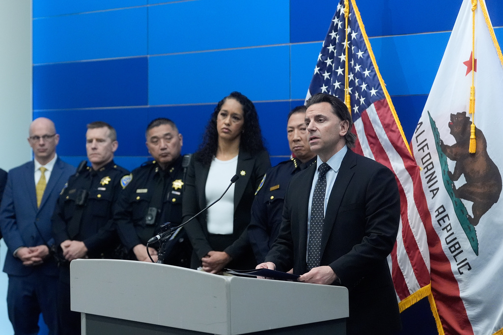 Matt Cobo, F.B.I. San Francisco Acting Special Agent in Charge, right, speaks next to San Francisco Police Chief Derrick Lew, second from right, and San Francisco District Attorney Brooke Jenkins, third from right, during a news conference Monday, April 13, 2026, in San Francisco. (AP Photo/Jeff Chiu)