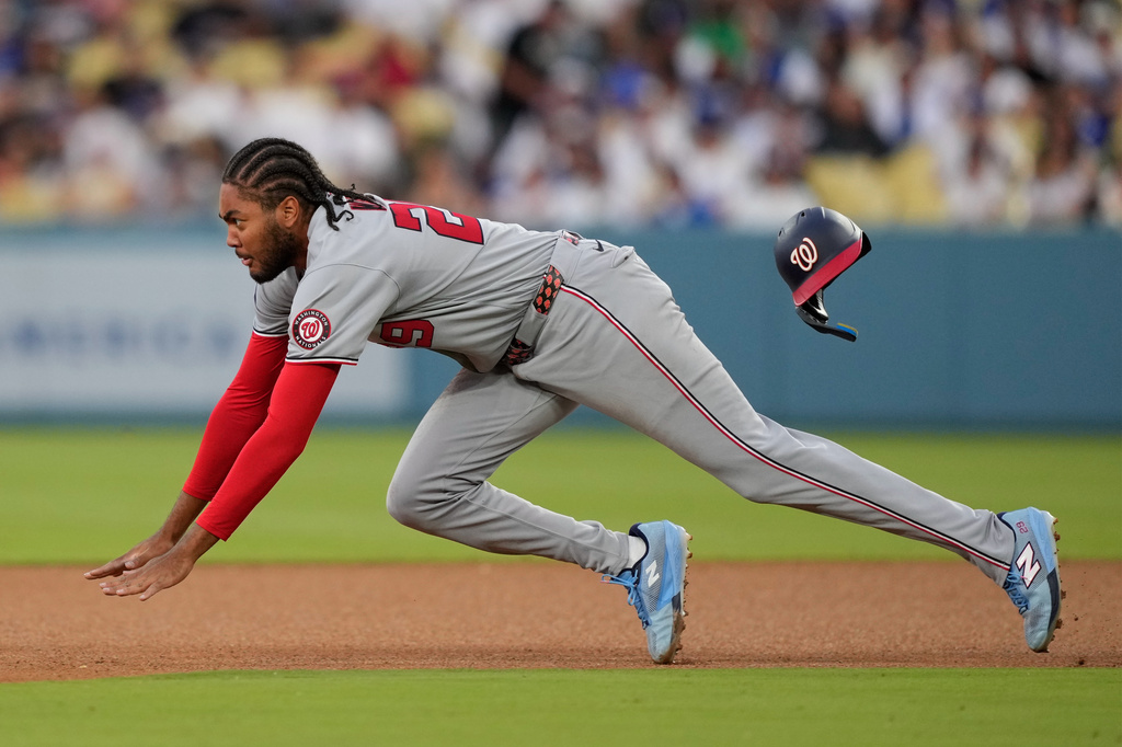 Washington Nationals' James Wood dives as he steals second during the third inning of a baseball game against the Los Angeles Dodgers, Saturday, Sept. 5, 2026, in Los Angeles. (AP Photo/Mark J. Terrill)