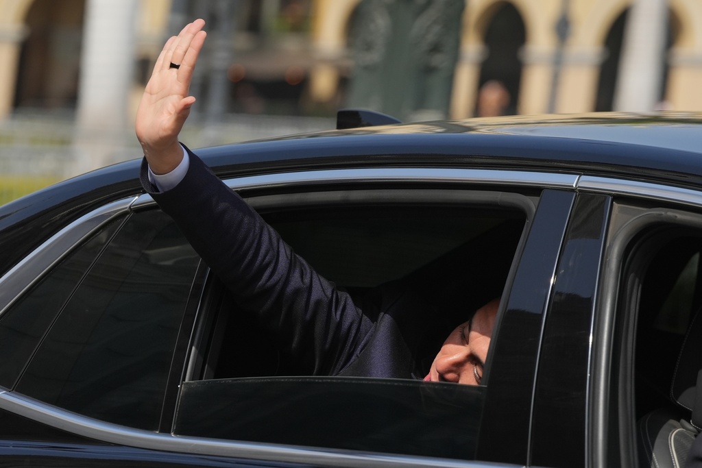Peru's interim President Jose Jeri waves to the press as he arrives at the government palace in Lima, Peru, Friday, Oct. 10, 2025, the day he was sworn-in after Congress voted to remove Dina Boluarte. (AP Photo/Guadalupe Pardo)