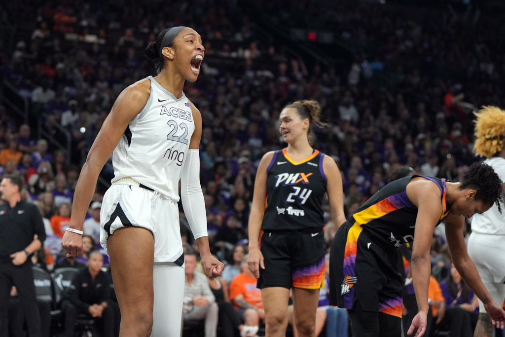 Las Vegas Aces center A'ja Wilson (22) reacts after scoring against the Phoenix Mercury during the first half of Game 4 of the WNBA basketball finals, Friday, Oct. 10, 2025, in Phoenix. (AP Photo/Rick Scuteri)