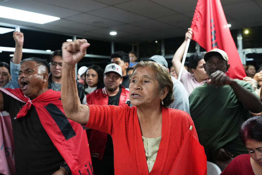 Supporters cheer for the ruling party presidential candidate Rixi Moncada at the party's headquarters in Tegucigalpa, Honduras, Monday, Dec. 1, 2025. (AP Photo/Moises Castillo)