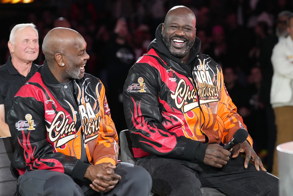 Former Miami Heat players Shaquille O'Neal, right and Gary Payton smiles during a half time celebration of the 2006 NBA champions Tuesday, Feb. 3, 2026, in Miami. (AP Photo/Marta Lavandier)