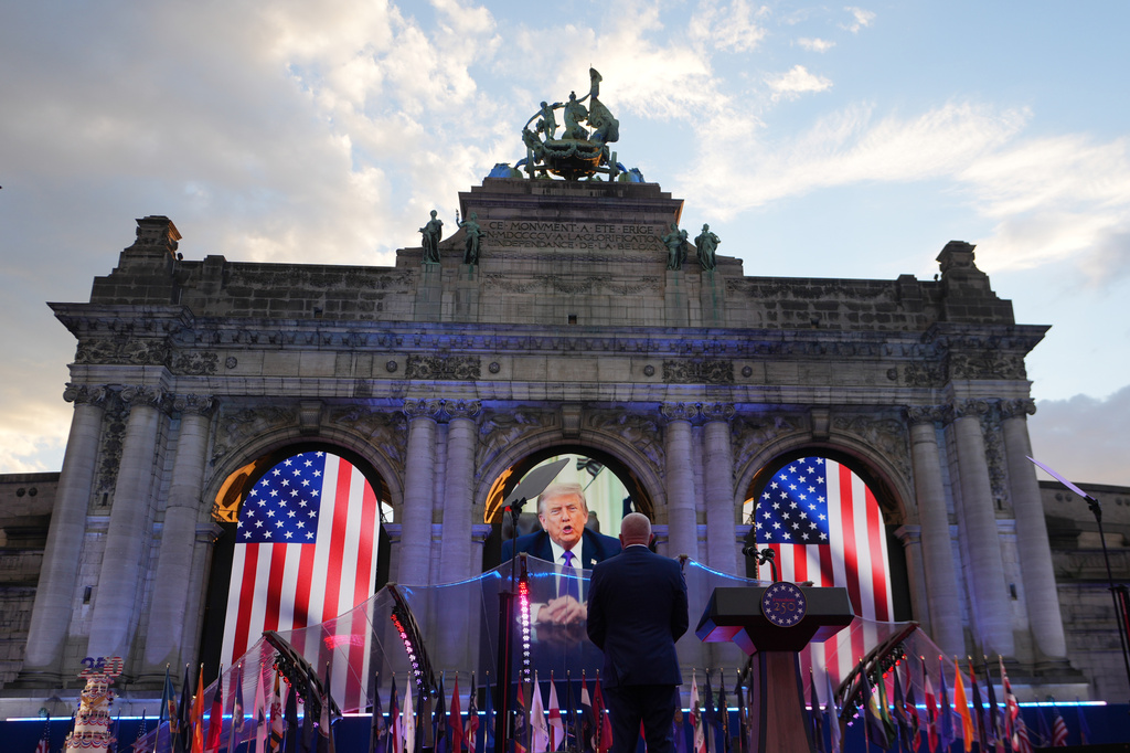 U.S. Ambassador to Belgium Bill White, center, listens to a pre-recorded address by U.S. President Donald Trump during the America 250 event in Brussels, Sunday, June 28, 2026. (AP Photo/Virginia Mayo)