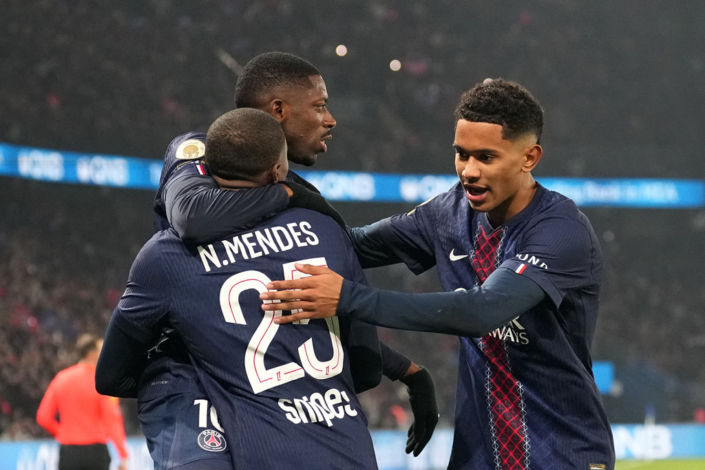 PSG's Ousmane Dembele, top left, celebrates with teammates after scoring the opening goal during the French League One soccer match between Paris Saint-Germain and Marseille in Paris, Sunday, Feb. 8, 2026. (AP Photo/Thibault Camus)