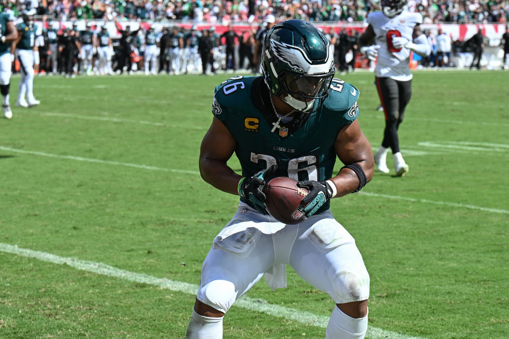Philadelphia Eagles running back Saquon Barkley (26) scores a touchdown during the second half of an NFL football game against the Tampa Bay Buccaneers, Sunday, Sept. 28, 2025, in Tampa, Fla. (AP Photo/Jason Behnken)