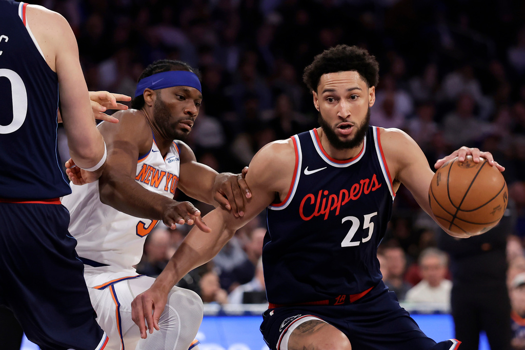 FILE - LA Clippers guard Ben Simmons drives past New York Knicks forward Precious Achiuwa during the first half of an NBA basketball game in New York, March 26, 2025. (AP Photo/Adam Hunger, File)