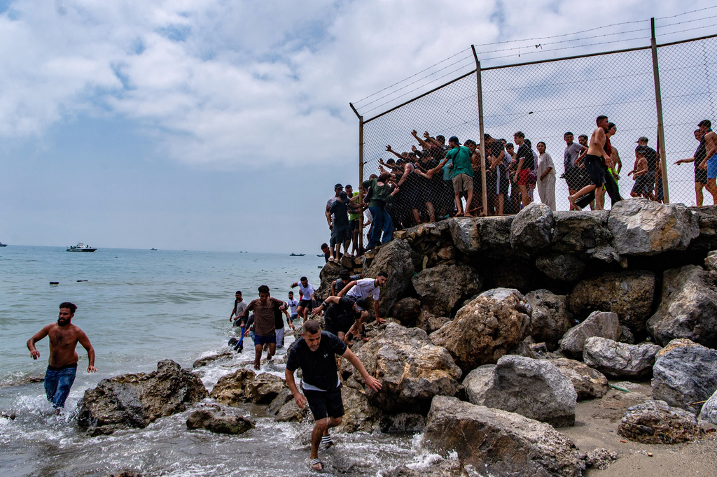 FILE - Migrants cross from Morocco into the Spanish enclave of Ceuta, Thursday, July 30, 2026. (AP Photo/Antonio Sempere, File)