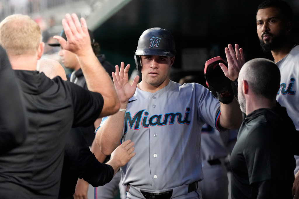 Miami Marlins' Jakob Marsee celebrates with teammates in the dugout after scoring against the Washington Nationals on a hit by Connor Norby during the sixth inning of a baseball game, Monday, June 1, 2026, in Washington. (AP Photo/Jess Rapfogel)