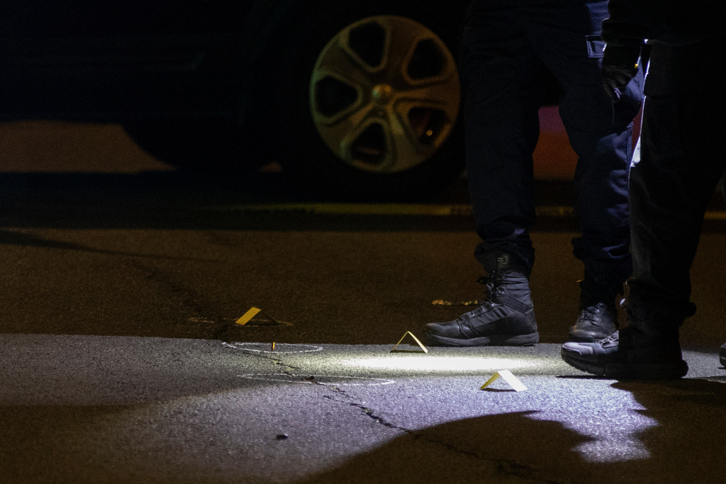 An officer with the San Francisco Police Department places a marker next to a piece of evidence at the scene of a shooting near Ocean Beach in San Francisco, Saturday, Nov. 8, 2025. (Stephen Lam/San Francisco Chronicle via AP)