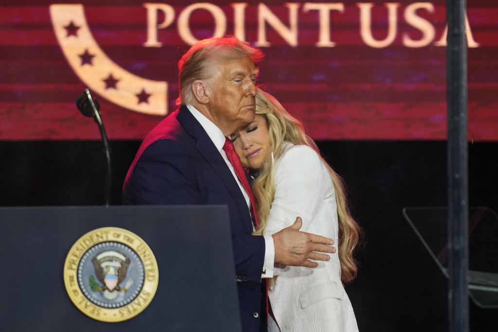 President Donald Trump embraces Erika Kirk at a memorial for conservative activist Charlie Kirk, Sunday, Sept. 21, 2025, at State Farm Stadium in Glendale, Ariz. (AP Photo/John Locher)