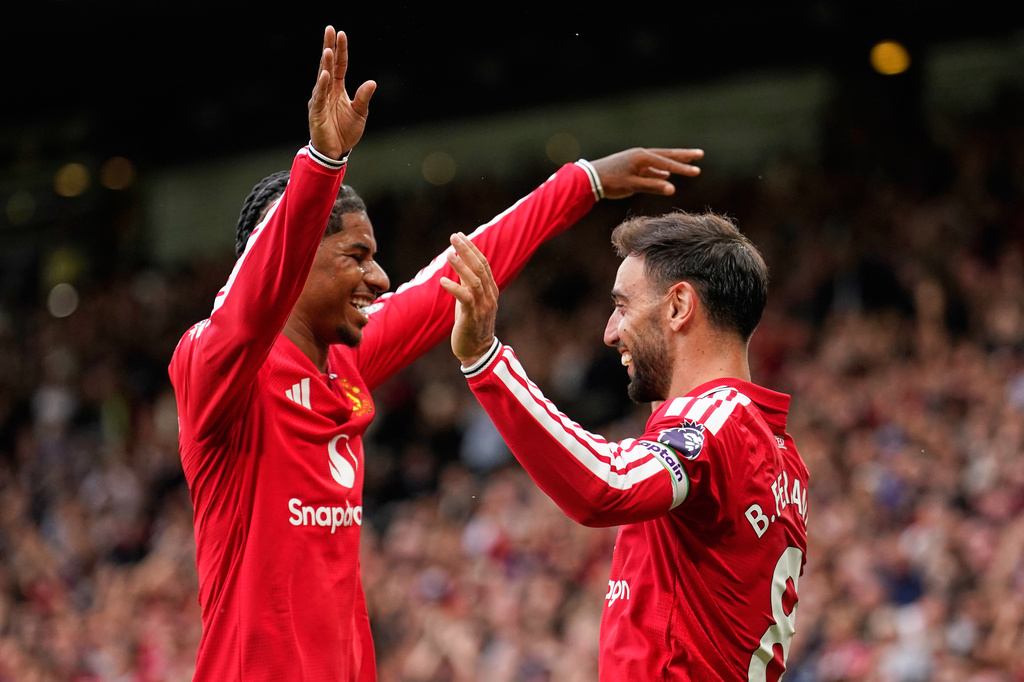 Manchester United's Bruno Fernandes, right, celebrates with Manchester United's Marcus Rashford after scoring his side's fourth goal during the English Premier League soccer match between Manchester United and Ipswich Town in Manchester, England, Sunday, Aug. 30, 2026. (AP Photo/Dave Thompson)