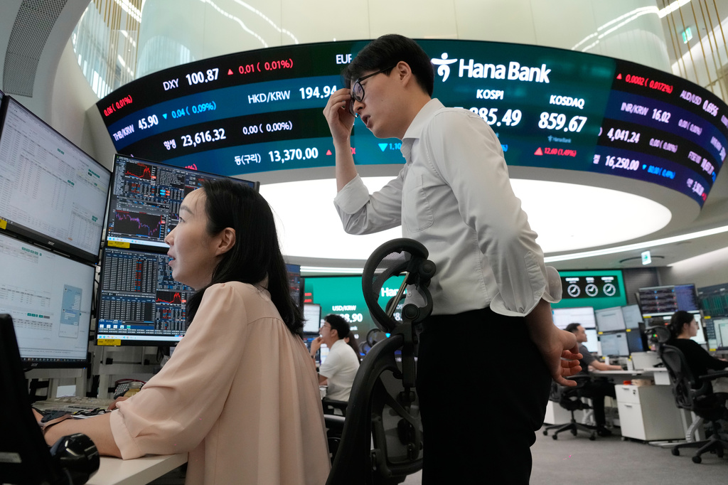 Currency traders watch monitors at the foreign exchange dealing room of the Hana Bank headquarters in Seoul, South Korea, Tuesday, July 7, 2026. (AP Photo/Ahn Young-joon)
