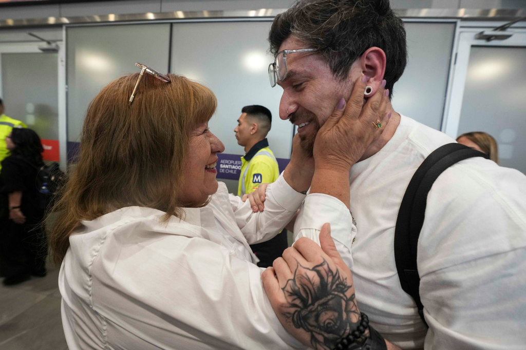 Kyle Adler, a 36-year-old Chilean American who was taken from his family at nine months old and illegally adopted, embraces his birth mother, Ana Maria Navarrete, after traveling from the U.S. to meet her for the first time, in Santiago, Chile, Saturday, Feb. 14, 2026. (AP Photo/Esteban Felix)