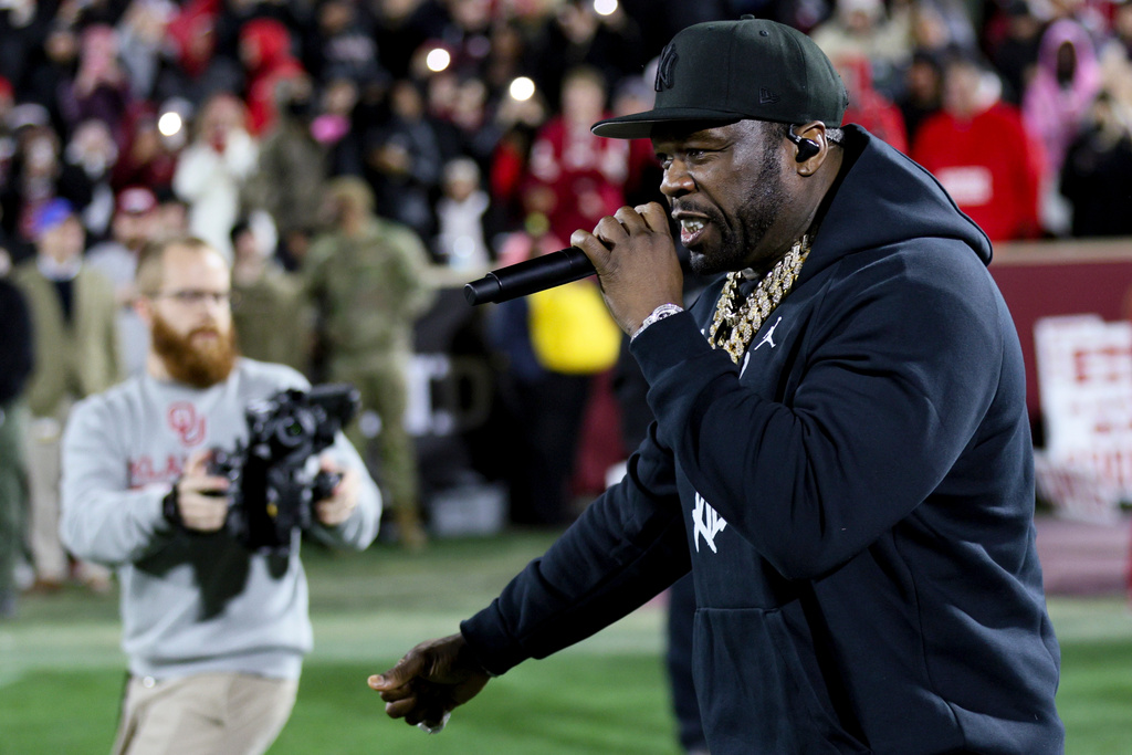 Rapper and actor 50 Cent performs during the second half in the first round of an NCAA College Football Playoff between Alabama and Oklahoma, Friday, Dec. 19, 2025, in Norman, Okla. (AP Photo/Nate Billings)