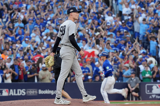 New York Yankees pitcher Will Warren, foreground, reacts as Toronto Blue Jays' Daulton Varsho, back right, rounds the bases after hitting a two-run home run during the fourth inning of Game 2 of baseball's American League Division Series in Toronto, Sunday, Oct. 5, 2025. (Frank Gunn/The Canadian Press via AP) New York Yankees pitcher Will Warren, foreground, reacts as Toronto Blue Jays' Daulton Varsho, back right, rounds the bases after hitting a two-run home run during the fourth inning of Game 2 of baseball's American League Division Series in Toronto, Sunday, Oct. 5, 2025. (Frank Gunn/The Canadian Press via AP)
