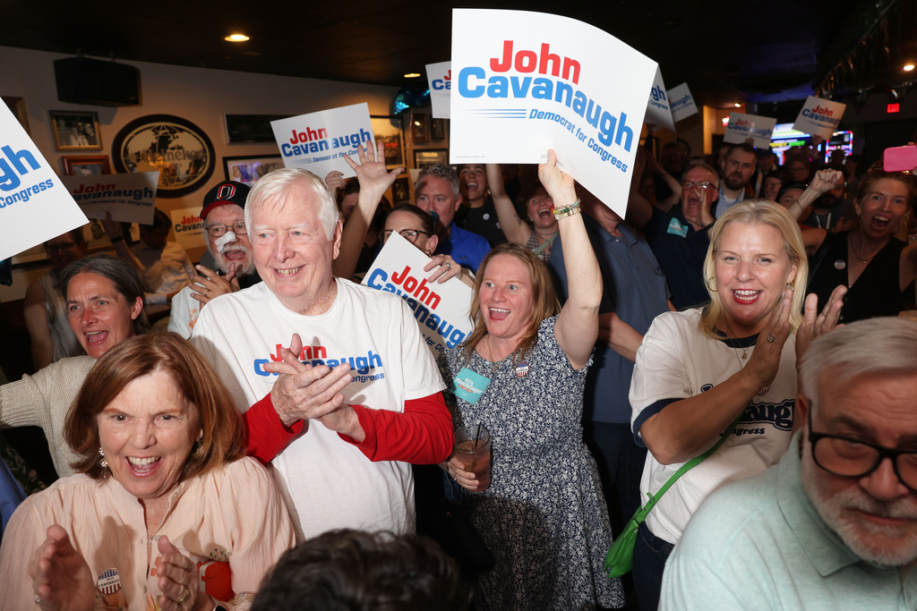 From front left, parents Kate and John Cavanaugh, sister-in-law Audra Cavanaugh and friend Michelle Sullivan cheer for State Sen. John Cavanaugh, candidate for the Democratic nomination to the House of Representatives in Nebraska's second district, during an election night watch party Tuesday, May 12, 2026, in Omaha, Neb. (AP Photo/Rebecca S. Gratz) ADDS NAMES
