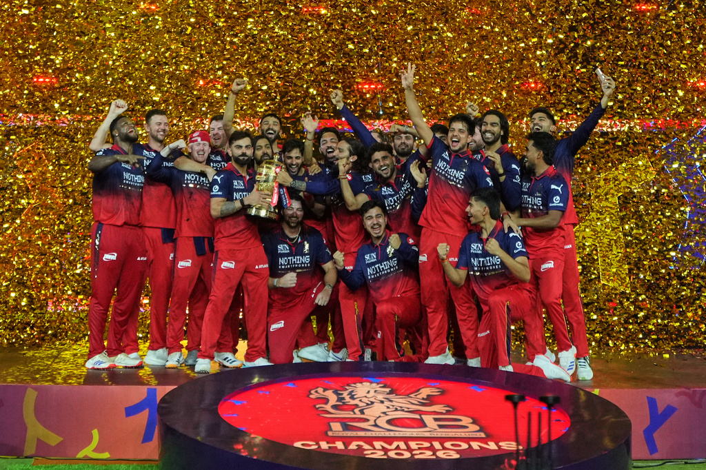 Royal Challengers Bengaluru players celebrate with winners trophy after their win in the Indian Premier League final cricket match against Gujarat Titans in Ahmedabad, India, Monday, June 1, 2026. (AP Photo/Ajit Solanki)