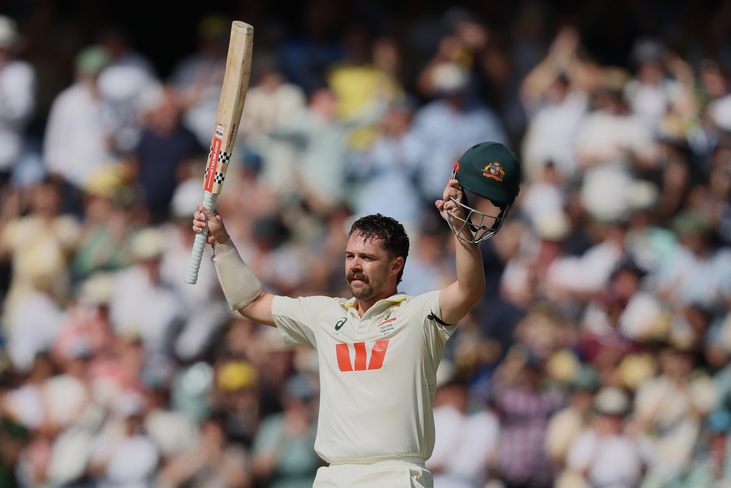 Australia's Travis Head celebrates after scoring century during play on day three of the third Ashes cricket test between England and Australia in Adelaide, Australia, Friday, Dec. 19, 2025. (AP Photo/James Elsby)