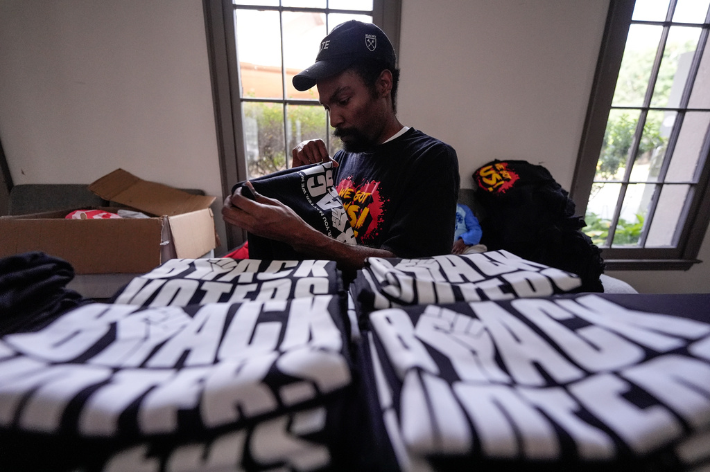 Nicholas Burns prepares his table at Bridgepointe Church during an event, Wednesday, Sept. 16, 2026, in Marietta, Ga. (AP Photo/Mike Stewart)