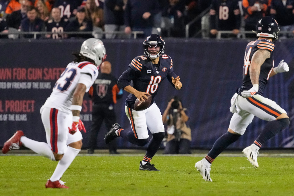 Chicago Bears quarterback Caleb Williams (18) scrambles as during the second half of an NFL football game against the New England Patriots in Chicago, Thursday, Oct. 22, 2026. (AP Photo/Nam Y. Huh)