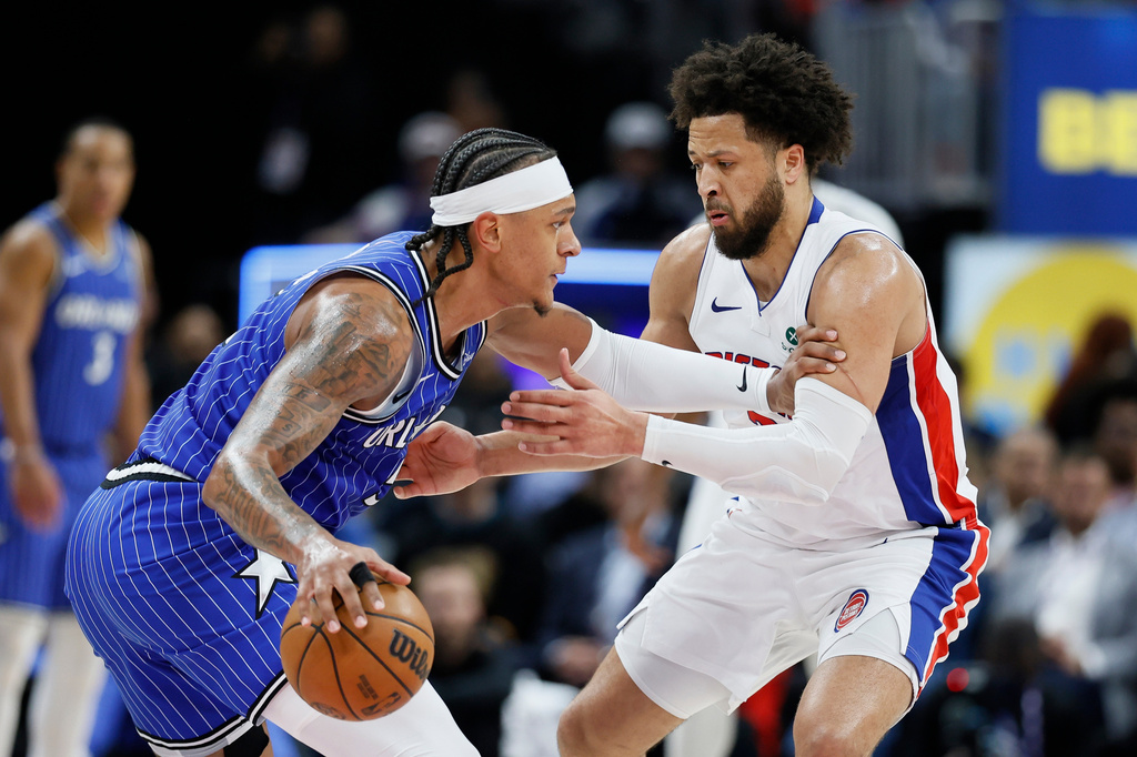 Orlando Magic forward Paolo Banchero, left, drives against Detroit Pistons guard Cade Cunningham, right, during the first half in Game 7 of a first-round NBA basketball playoffs series Sunday, May 3, 2026, in Detroit. (AP Photo/Duane Burleson)