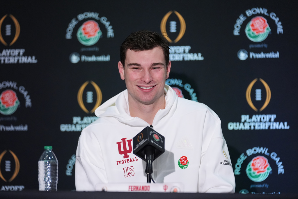 Indiana quarterback Fernando Mendoza (15) answers questions during a press conference ahead of Thursday's Rose Bowl College Football Playoff against Alabama Tuesday, Dec. 30, 2025, in Los Angeles. (AP Photo/Marcio Jose Sanchez)