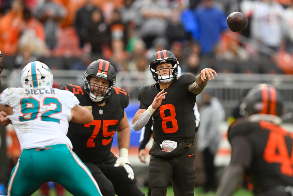 Cleveland Browns quarterback Dillon Gabriel (8) passes as guard Joel Bitonio (75) blocks Miami Dolphins defensive tackle Zach Sieler (92) in the second half of an NFL football game in Cleveland, Sunday, Oct. 19, 2025. (AP Photo/David Richard)