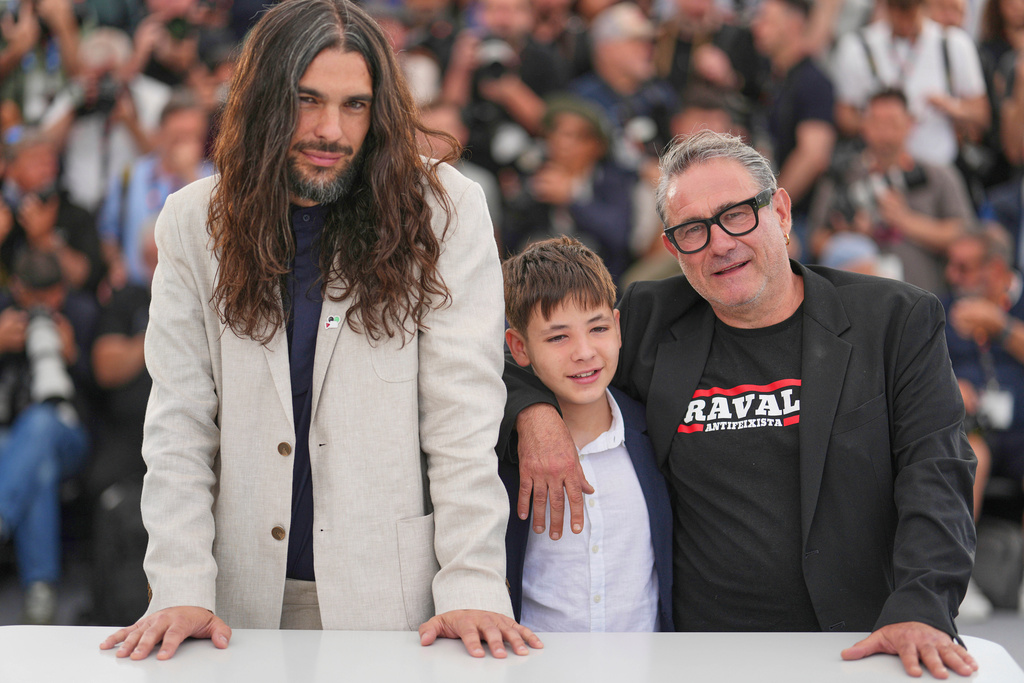 FILE- Director Oliver Laxe, from left, Bruno Nunez, and Sergi Lopez appear at the photo call for the film "Sirat" at the 78th international film festival, Cannes, southern France on May 16, 2025. (Photo by Lewis Joly/Invision/AP, File)
