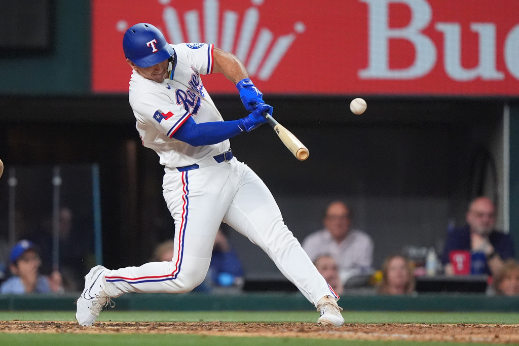 Texas Rangers' Wyatt Langford hits a runs scoring single in the ninth inning of a baseball game against the Los Angeles Angels, Thursday, July 9, 2026, in Arlington, Texas. (AP Photo/LM Otero)