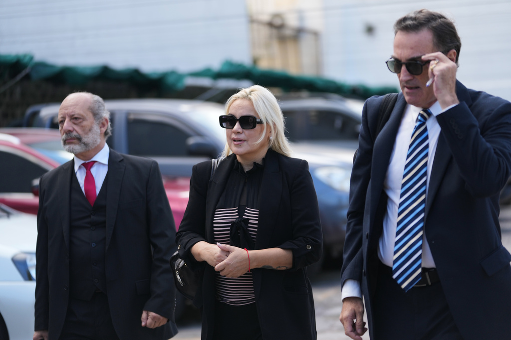 Veronica Ojeda, center, the former partner of the late soccer star Diego Maradona, arrives to court for the first day of the trial of his medical team for alleged homicide by negligence in San Isidro, Argentina, Tuesday, April 14, 2026. (AP Photo/Rodrigo Abd)