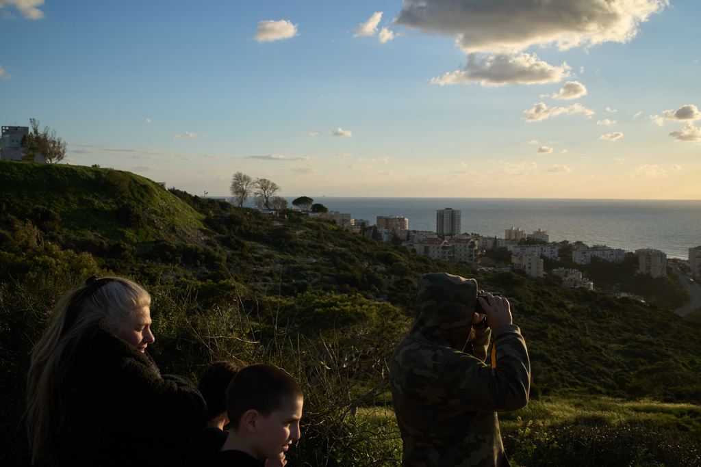 From a lookout, a man uses a binocular looking for the possible arrival of the US Navy's aircraft carrier USS Gerald R. Ford in the Mediterranean Sea near the coast of Haifa, northern Israel, Friday, Feb. 27, 2026. (AP Photo/Leo Correa)