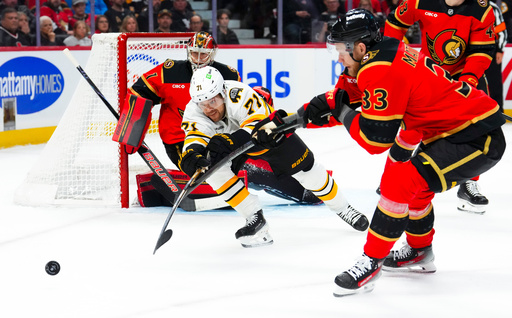 Ottawa Senators' Nikolas Matinpalo (33) pushes Boston Bruins' Viktor Arvidsson (71) off the puck as Ottawa Senators goaltender Leevi Merilainen (1) keeps his eye on it during the first period of an NHL hockey game in Ottawa on Monday, Oct. 27, 2025. (Sean Kilpatrick/The Canadian Press via AP) Ottawa Senators' Nikolas Matinpalo (33) pushes Boston Bruins' Viktor Arvidsson (71) off the puck as Ottawa Senators goaltender Leevi Merilainen (1) keeps his eye on it during the first period of an NHL hockey game in Ottawa on Monday, Oct. 27, 2025. (Sean Kilpatrick/The Canadian Press via AP)