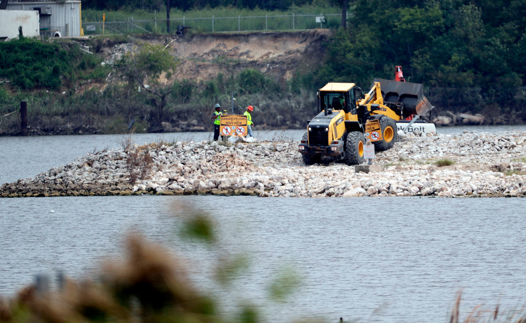 FILE - Work continues at San Jacinto River Waste Pits, a Superfund site, near the Interstate 10 bridge over the river in Channelview, Texas on Sept. 13, 2017. (AP Photo/David J. Phillip, File)