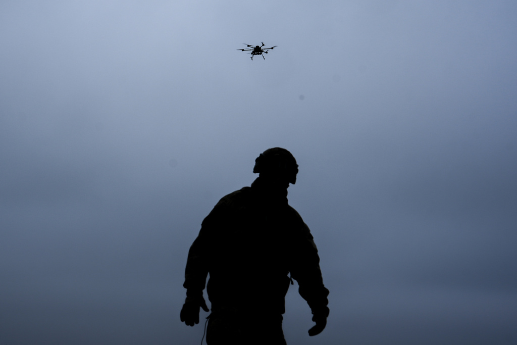 A Ukrainian soldier with the Kraken 1654 unit watches a Vampire drone fly overhead during a demonstration for The Associated Press, Wednesday, Nov. 5, 2025, in Kharkiv Oblast, Ukraine. (AP Photo/Julia Demaree Nikhinson)
