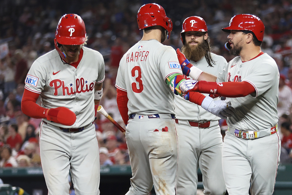 Philadelphia Phillies' Kyle Schwarber celebrates with his teammates after hitting a home run during the seventh inning of a baseball game against the Washington Nationals, Friday, Aug. 15, 2025, in Washington. (AP Photo/Daniel Kucin Jr.)