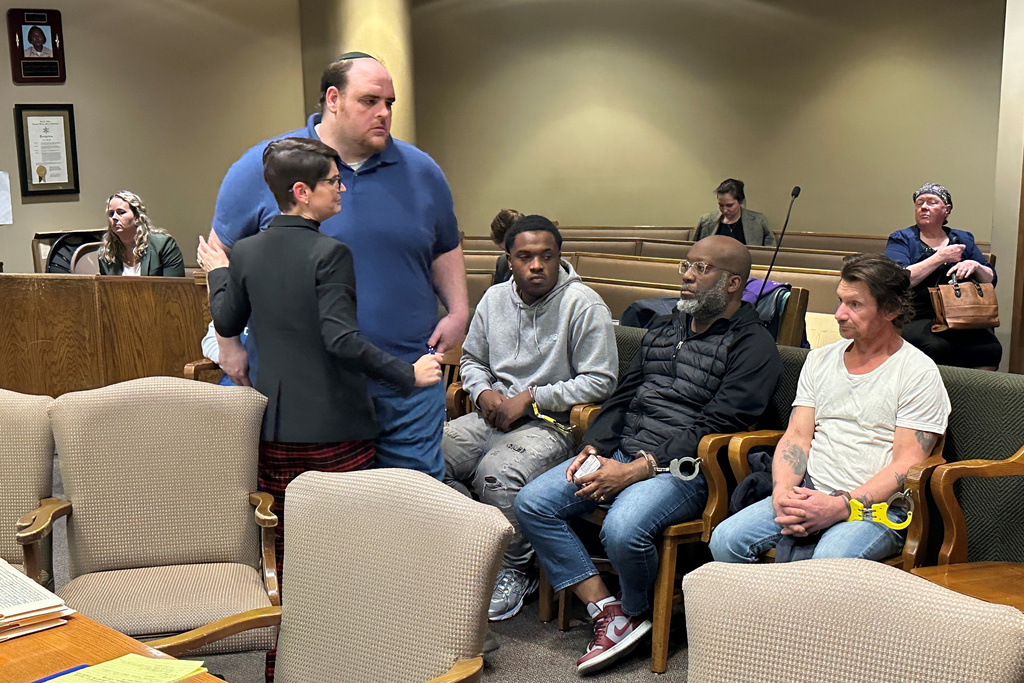 Joel Bowman, standing second left, speaks with his lawyer Lauren Fuchs at the conclusion of a court hearing on Friday, Dec. 12, 2025, in Memphis, Tenn. (AP Photo/Adrian Sainz)
