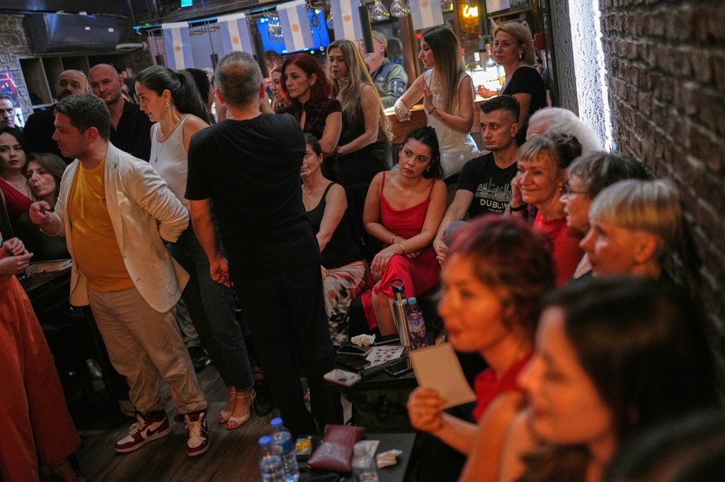 Tango enthusiasts sit and watch others dance during a milonga session at La Cumparsita in Istanbul, Turkey, Tuesday, Jan. 27, 2026. (AP Photo/Francisco Seco)